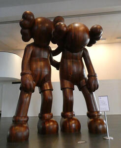 Large (3-4 meter) wood sculpture of two cartoonish figures