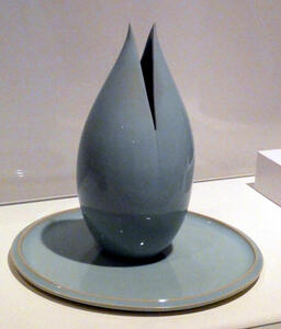 Blue ceramic jar in shape of opening flower bud