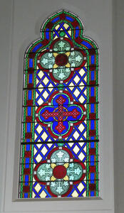 Stained glass window with cross in center