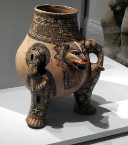 Pitcher with carved relief wolf head on side
