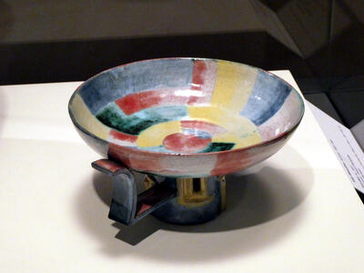 Ceramic bowl with blue, green, red, and yellow color strips, both horizontal and vertical