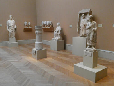 Room with several statues and busts in Roman style