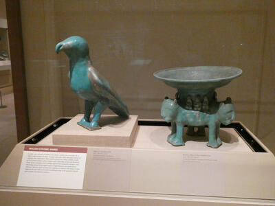 Ceramic predatory bird and bowl molded on base of three lions