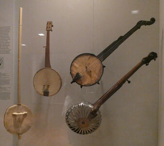 Four banjos, ranging in quality from primitive to sophisticated