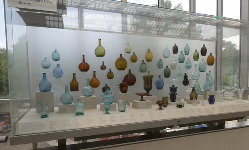 Large array of glass bottles/vases of American manufacture in several colors