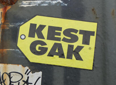 Yellow sticker with black print, looks just like a Best Buy sticker but has the text KEST GAK