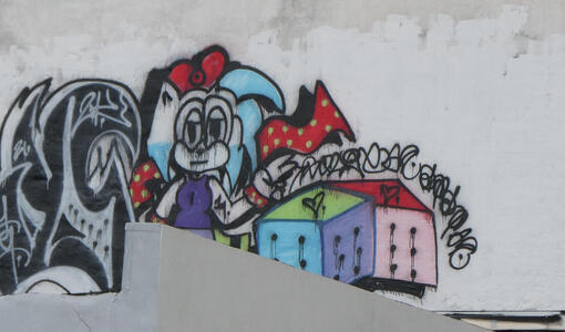Graffitti of girl with red bow in blue hair