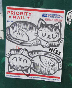 Priority Mail sticker on which someone has drawn two sleeping cats