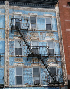 Building with faded blue paint on brickwork