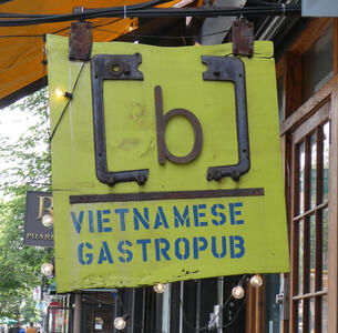 Sign with letter “b” between two metal braces; text VIETNAMESE GASTROPUB beneath