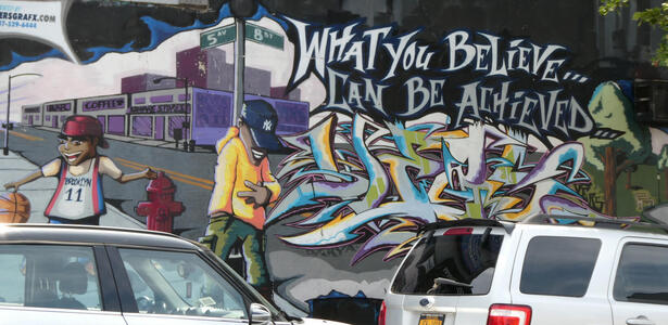 Wall mural: boy with basketball, man with baseball cap. text:“What can be believed can be achieved”