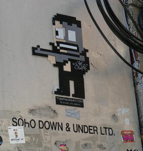 Video game style figure holding a rifle; text beneath says SOHO DOWN & UNDER LTD.