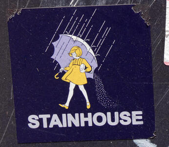 Girl in yellow dress with umbrella pouring salt behind her. Text beneath: STAINHOUSE
