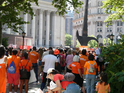 Crowd of peole wearing orange shirts and hats