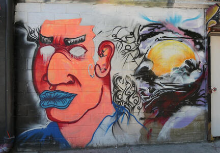 Wall painting of man with large nose and blue lips
