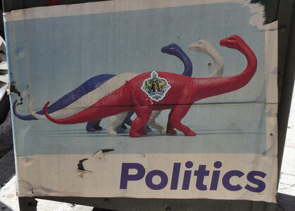 Red, white, and blue dinosaurs. Text beneath: Politics