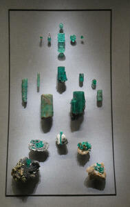 Polished jade at top of display, raw jade mineral samples at bottom