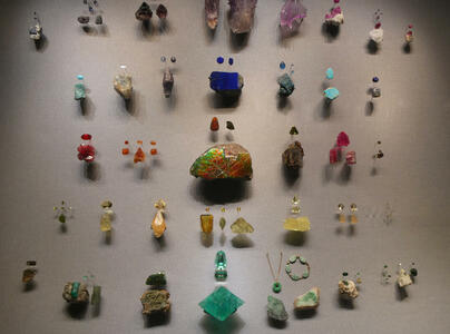 Display of cut and raw gemstones in various colors