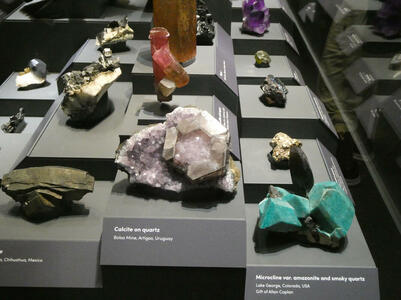 Clear quartz, green microcline, red mineral in background