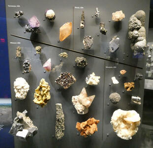 Display of mostly yellow mineral samples