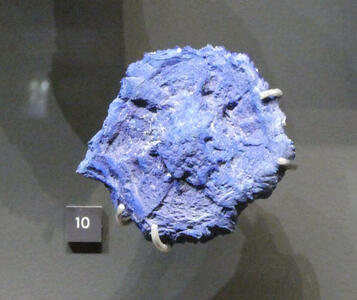 Roughly circular blue mineral sample