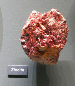 Reddish-orange mineral sample (zincite)