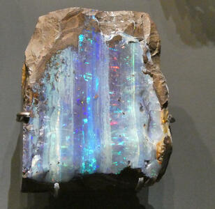 Iridescent blue vertical stripes in mineral sample