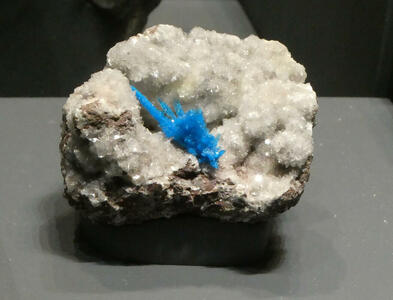 Blue pentagonite crystal on larger white stilbite crystal