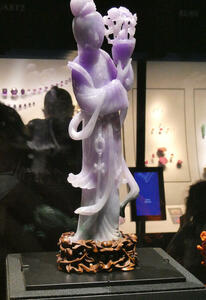 Carving of person in purple jadeite