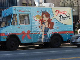 Sign on a food truck “Pinup Panini”, with image of young woman