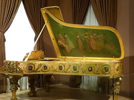 Grand piano with painting of women on inside of lid