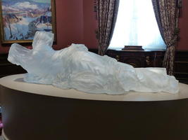 life-size woman's dress in reclining position; made of frosted glass.