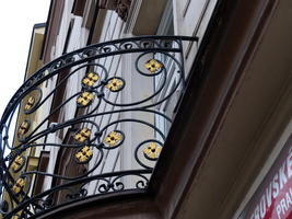 Wrought-iron balcony with gold star shapes embedded in curves