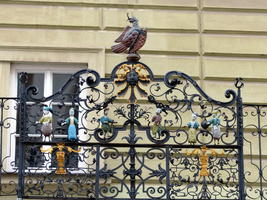 Wrought iron balcony rail with fanciful painted figures