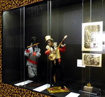 Two humanoid automata in blackface, one with flute, the other with banjo.