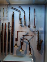 Wind instruments, some with right angles in their wind tubes