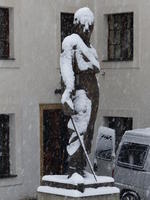 Snow-covered sculpture of man with sword