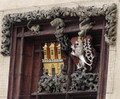 Detail of relief; gold three-towered building and lion with gold crown