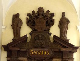 Wooden sculptures above senate door in clock tower building