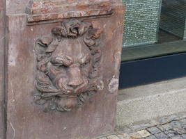Relief-work lion at base of a building column
