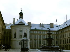 Round white building and fountain at entrance to Prague Castle
