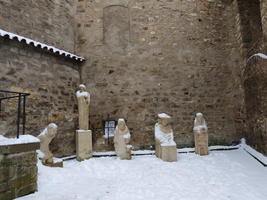 Small white statues of religious figures at end of Golden Lane