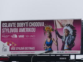 BIllboard with women dressed as Aztec and Native American.