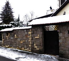 garage door and wall made of varying-colored bricks