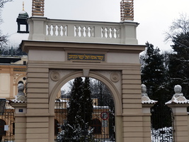 Arched entry to Hebrew cemetery, with hebrew lettering above arch