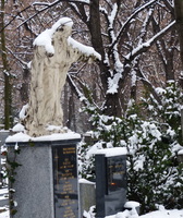 Statue of Jesus above a grave in Christian cemetery