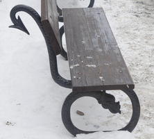 Park bench with legs and back support in form of dragon with barbed tail