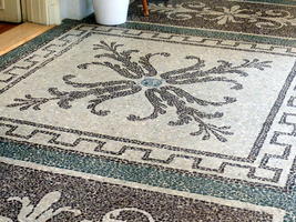 Geometric flower-like design in floor mosaic
