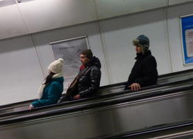 People appearing to lean backward on escalator