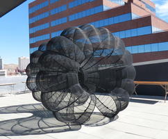 Dumbbell-shaped wire sculptue on roof of museum